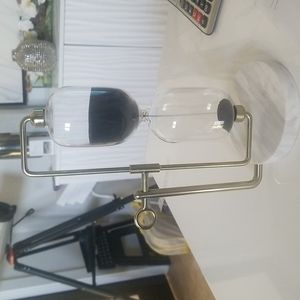 Glass and marble hourglass with black sand
